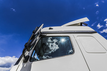 Summer sky over the cabin of a white truck