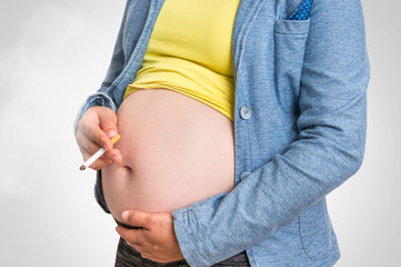 Pregnant woman with cigarette - smoking addiction concept