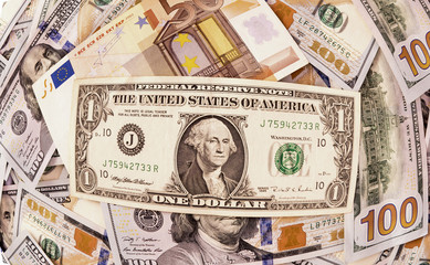 One dollar over a fifty euro note and hundred dollars as background