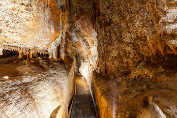 Narrow footpath in limestone cave