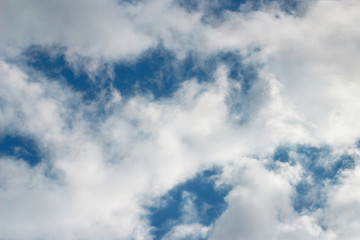 Blue sky on a windy day, covered with white clouds