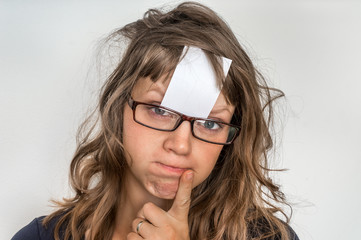 Fototapeta premium Funny woman with blank white sticky paper over her forehead