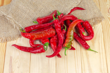 Red peppers chili on a burlap and wooden surface