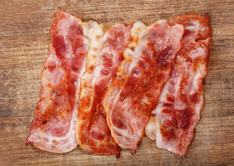 fried bacon on wooden board