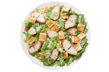 plate of chicken caesar salad isolated on white background