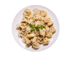 Plate of traditional russian pelmeni, ravioli or dumplings on white background, top view