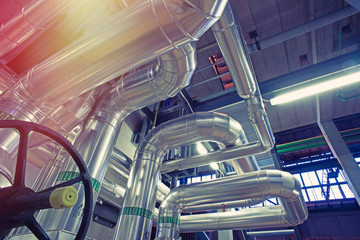 Equipment, cables and piping as found inside of a modern industrial power plant