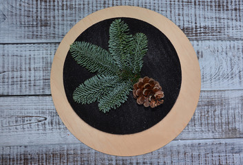 Christmas chocolate velvet cake decorated with pinecone on wood