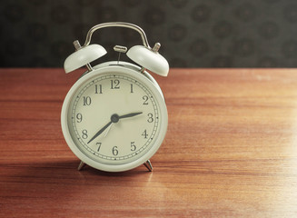 alarm clock on wooden.
