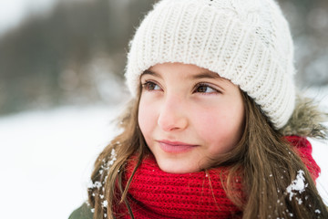 Portrait of a small girl in winter nature.