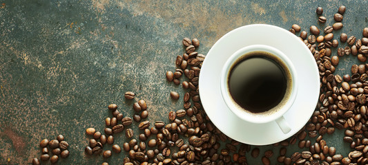 Cup of hot espresso coffee with full roast beans