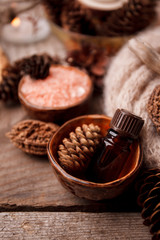 Close up of beautiful spa composition in wellness center, Spa ftreatmeent, aromatherapy oil and Pine cones, monochrome concept