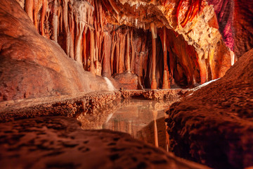 Stalactites and water pond in a limestone cave in Australia