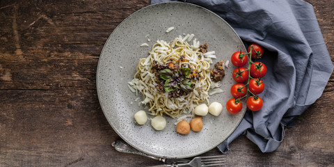 Spaghetti with pesto sauce, mushroom pate and smoked Bocconchini cheese. Food banner