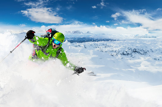 Alpine freeride skier with snow powder explosion