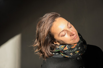 The young lady enjoying the sun rays at sunset in the tunnel