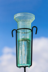 Water meter with rainwater and cloud in sky