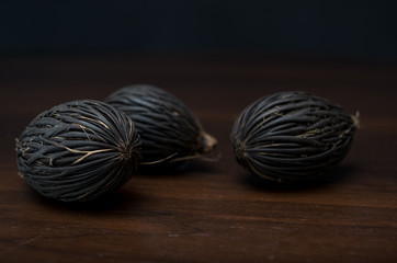 Among these exotic Foxtail palm seeds. Wodyetia bifurcata. Black, brown amazing seeds on black...