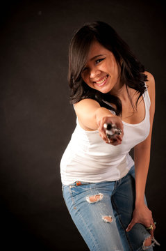 Fashion portrait in studio of beautiful young woman feeling happy with her flute against dark background in studio