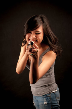 Fashion portrait in studio of beautiful young woman feeling happy with her flute against dark background in studio