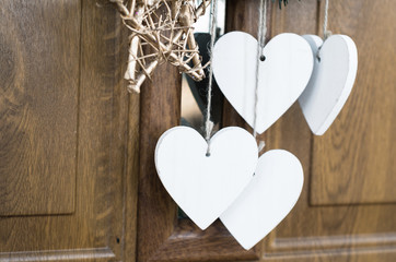 Wooden heart shape hanging under christmas wreath, copy space