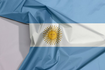 Argentina fabric flag crepe and crease with white space, a horizontal triband of light blue (top and bottom) and white with the Sun of May centered on the white band.