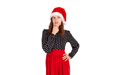 Dreamy attractive, thinking and confident young woman in dress, holding palm on cheek and gazing at upper left corner. emotional girl in santa claus christmas hat isolated on white background