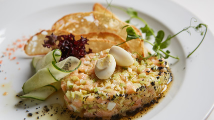 The salmon tartare with avocado. Shallow dof