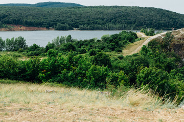 landscape river cliff grass on the sky background