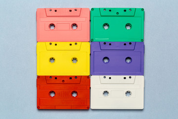 Bright retro cassette tapes on a light grey background