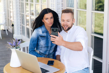 Lovers call parents on video communication, communicate and smile. Parney introduces his parents to the girl. Concept people, gadgets, technology.