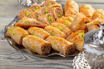 Turkish sweets baklava and metal oriental tray on wooden background