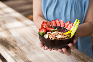 woman holding a breakfast bowl