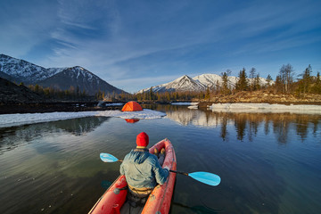 Man paddling kayak in mountain lake. Freedom.