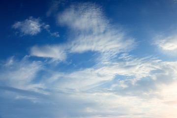 Transparent white clouds in a light blue sky. Heaven promised. Background from the light cloudy sky.