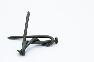 The nail is bent. Twisted two nails on isolated background.