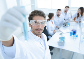 tube with reagents on blurred background laboratory.
