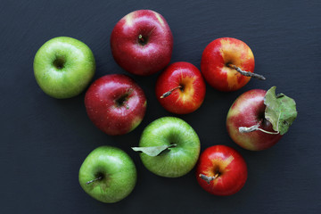 Apples on dark background, green and red apples