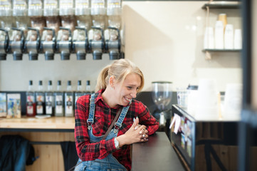 funny laughing american trendy caucasian girl laughing sitting in coffehouse