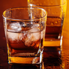 Glass of scotch whiskey with natural ice .