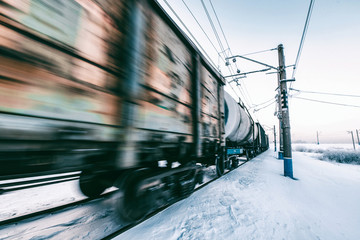 Winter railway and train with cargo.