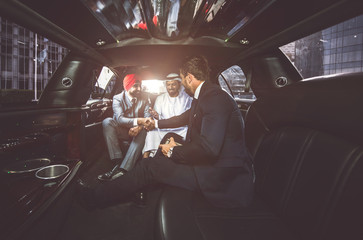 Business team talking about future plans in Dubai in the limousine