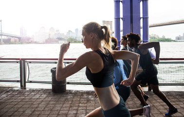Obraz premium Group of urban runners running on the street in New york city, conceptual series about sport and fitness