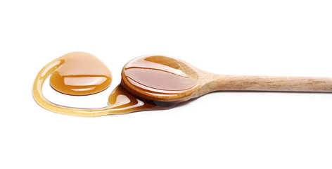 Honey with wooden spoon isolated on white background