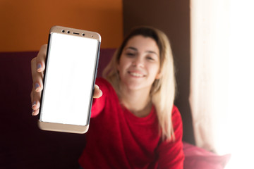 Girl showing a blank screen of the smartphone to the camera