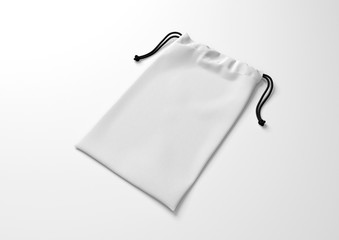 White drawstring bag on white background. Fabric cotton small bag. Isolated pouch.
