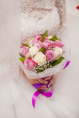 bride holds a bouquet. wedding in shades of lilac