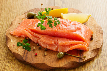 A piece of salted salmon on a board.
