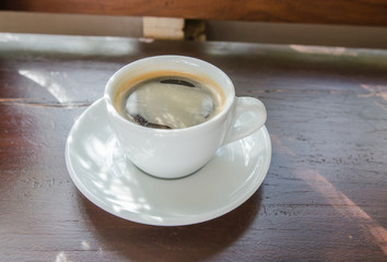 Black coffee on a wooden table in a coffee shop