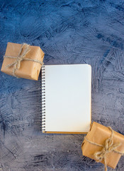 Fir and Christmas gifts on a black table, top view
